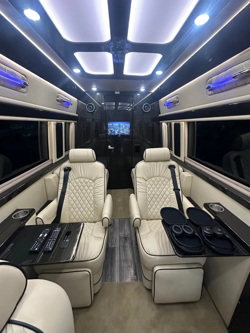 Reclining leather seats and ambient lighting inside the private Sprinter.